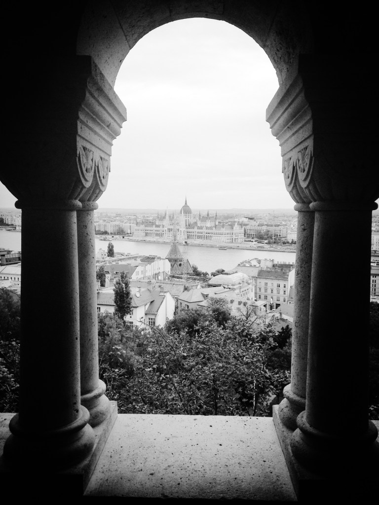 Photograph. 'Fisherman's Bastion, Budapest, Hungary.'  View of the Hungarian Parliament Building from the Fisherman's Bastion, on the Buda side of the Danube. Buda is the ancient capital of Hungary, and one of three territories that make up the modern city of Budapest. In 1686 Buda was reconquered from the Ottoman Empire.@davidasutton @sketchbookexplorer Facebook.com/davidanthonysutton #b&w #photography #budapest #hungary #travel #travelblog #buda #fishermansbastion