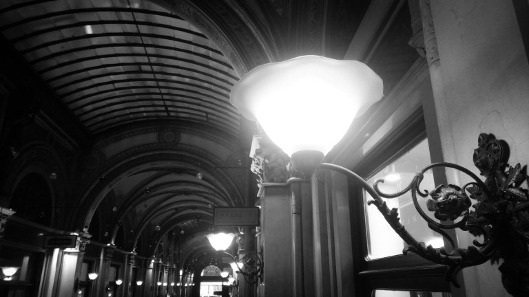 Urban photo - Vienna, Austria. 'Freyung Passage.' Once home to the stock exchange, this elegant shopping arcade cuts through the Palais Ferstel. The perfect place to shelter from the winter weather in style. sketchbookexplorer.com @davidasutton @sketchbookexplorer Facebook.com/davidanthonysutton #photograph #b&w #vienna #travel #travelblog #freyungpassage