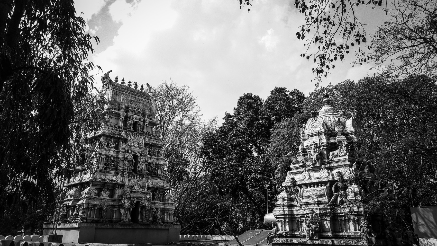 Urban photo art – Bull Temple Road, Basavanagudi, Bengaluru, Karnataka, India. ‘Dodda Ganesha Temple.’ Frequented by Bollywood stars, before films start rolling, the temple played a part in the Anglo Mysore War of 1791. Plans for the war were set out within the temple's grounds. sketchbookexplorer.com @davidasutton @sketchbookexplorer Facebook.com/davidanthonysutton #photograph #photography #blackandwhite #bangaluru #karnataka #temple #hindutemple #bulltemplebengaluru #hindu #travel #travelblog #india
